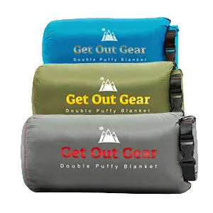 Three rolled-up camping blankets in blue, green, and gray, each with Get Out Gear Double Puffy Blanket and a mountain logo printed on the front. The blankets are stacked vertically.