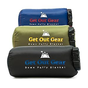 Three rolled-up Get Out Gear Down Puffy Blanket bags in blue, green, and black, stacked on top of each other with visible logos and mountain graphics.