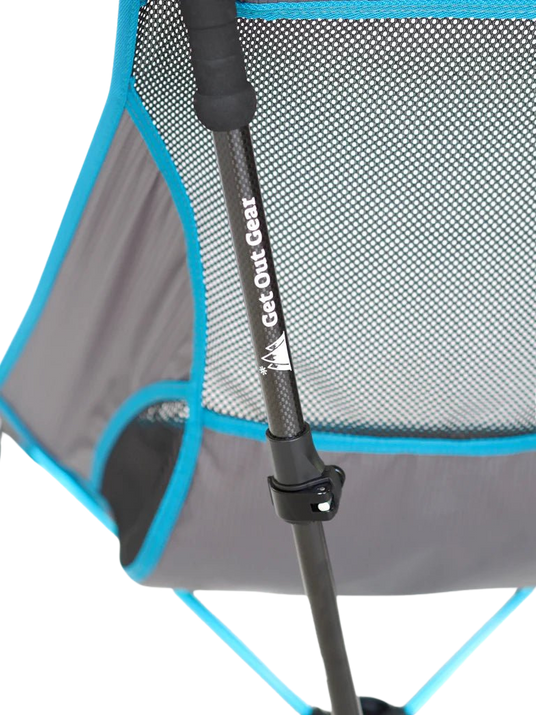 Close-up of a portable camping chair with a mesh back and blue trim. A black pole with the Get Out Gear logo is attached to the chair’s frame.