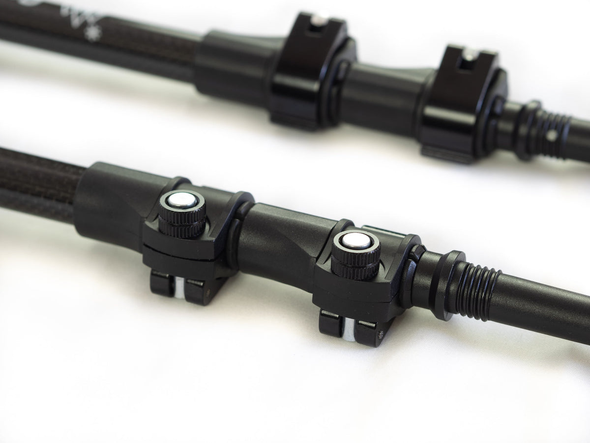 Close-up of Get Out Gear Goat Stix trekking pole flip-lock mechanisms with all-metal construction on carbon fiber shafts, showing adjustable clamps and durable build.