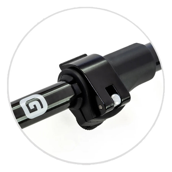 Close-up of a black latch locking mechanism on a metal pole with a white G logo, set against a white background within a circular frame.