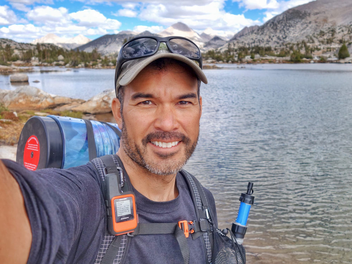 Get Out Gear founder Jon Davis by a rocky river in the wilderness