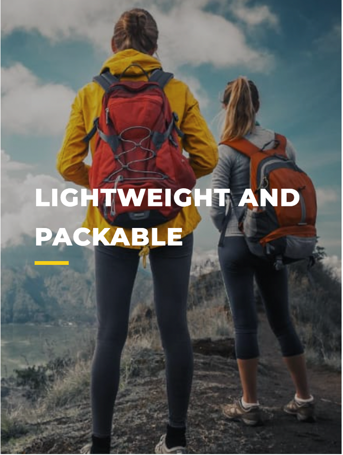Two women wearing backpacks and outdoor gear stand on a mountain trail overlooking a scenic landscape, with the words LIGHTWEIGHT AND PACKABLE written across the image.
